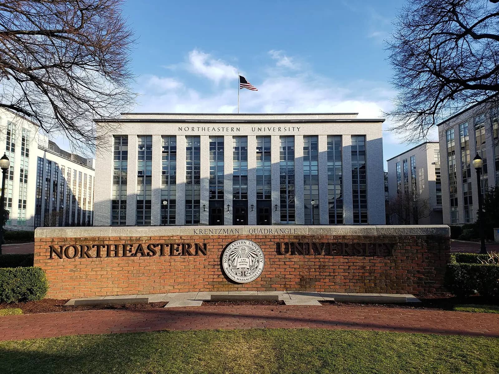 Northeastern University campus — The Northeastern University sign at Krentzman Quad, viewed from Huntington Ave with Ell Hall in the background, often vi
